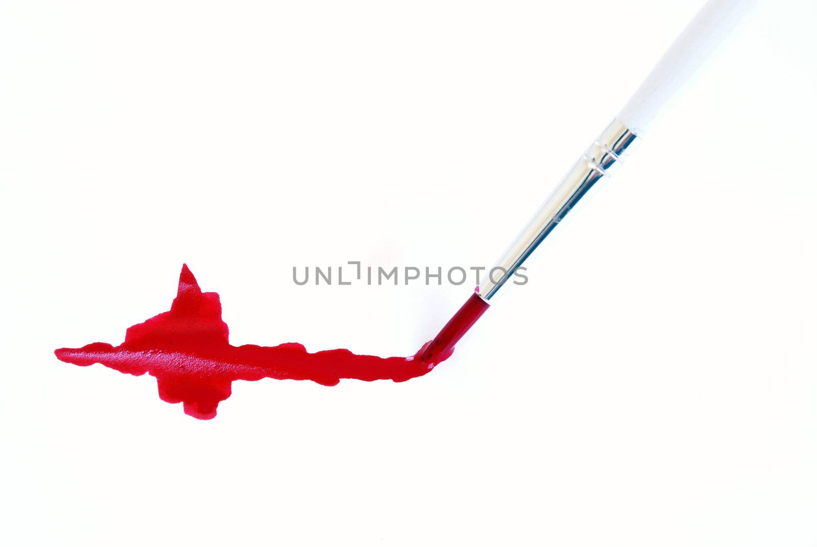 A paint brush making a red stroke of paint.