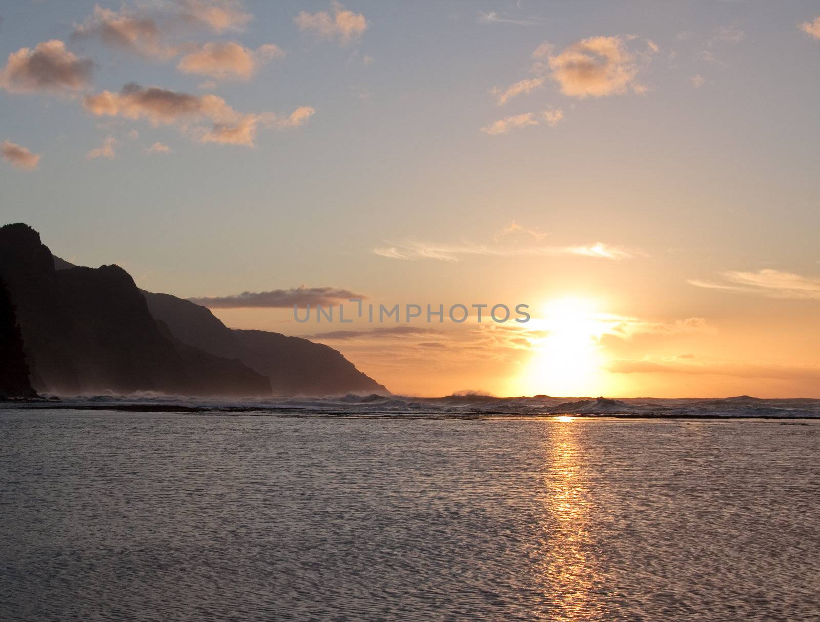 Kauai sunset highlighting the rugged coastline of Na Pali