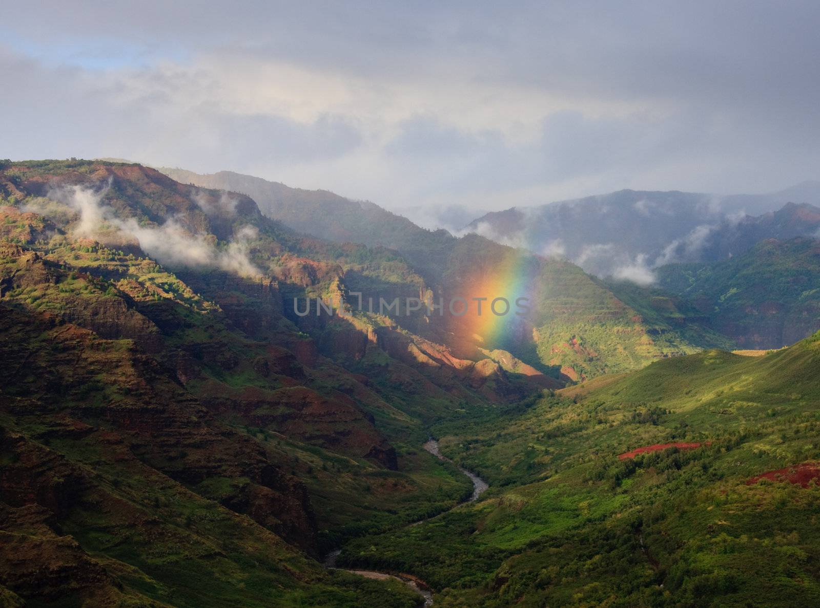 Rainbow falling on river in Waimea Canyon by steheap