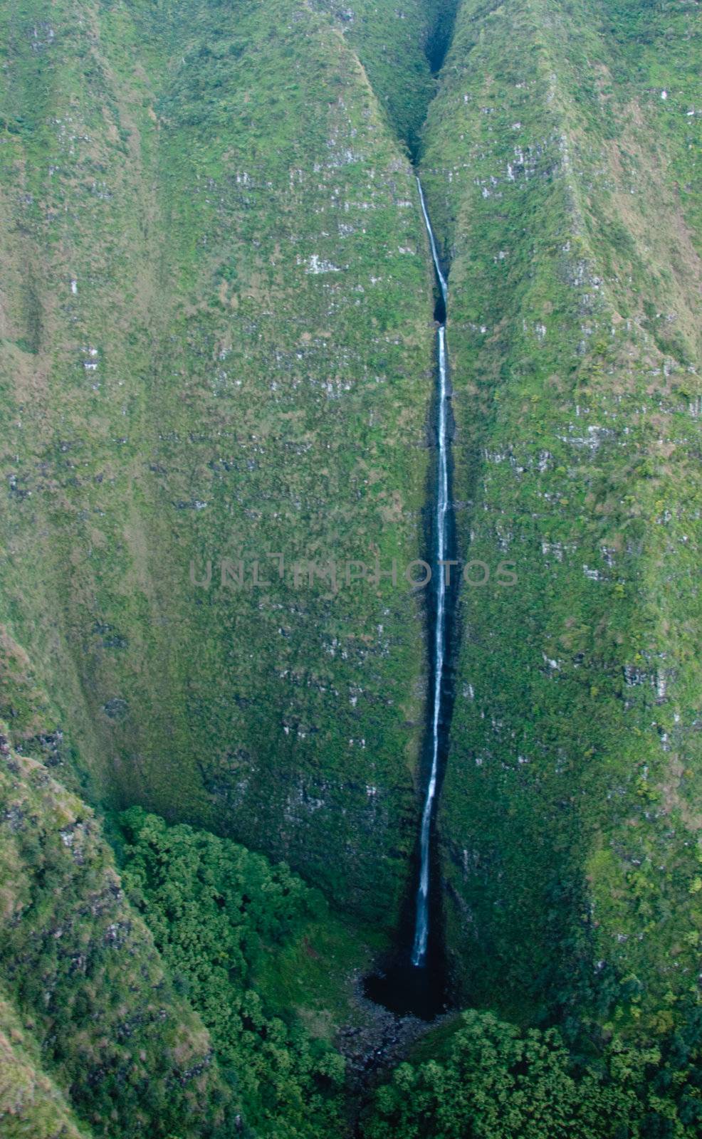 Waterfall streaming down the rock face of Mt Waialeale in Kauai