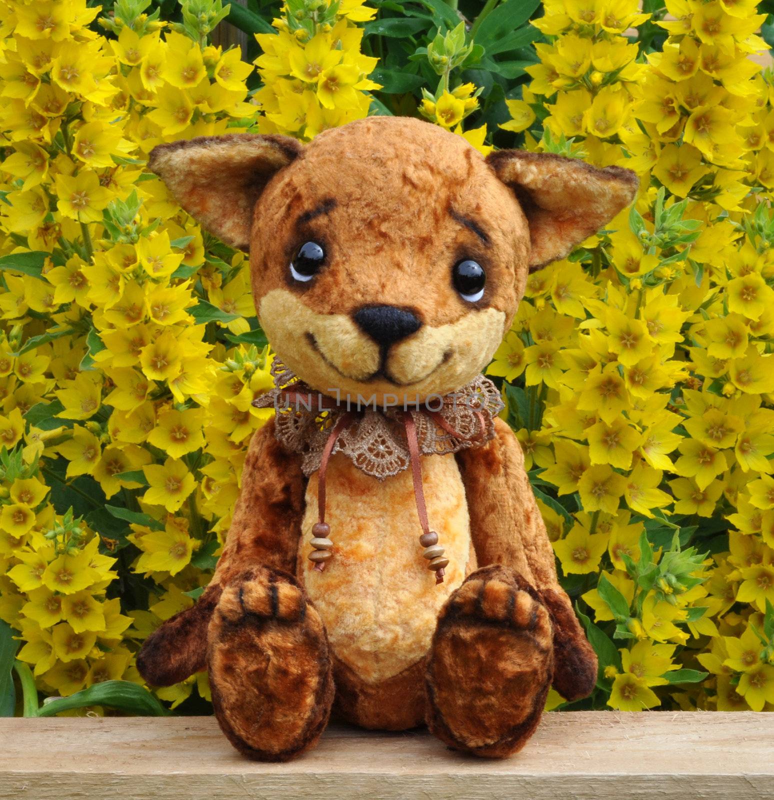 Handmade, the sewed plush toy: Ron fox cub on a board among flowers