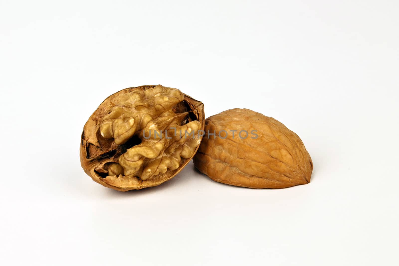 Beaufiful composition of a walnut isolated on white background.