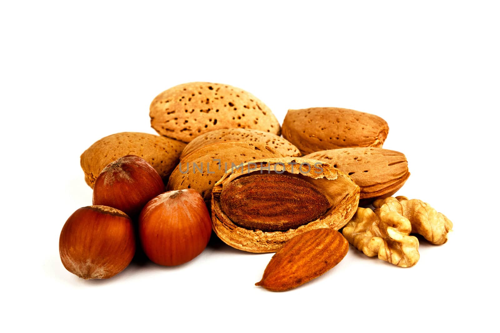 Composition of almonds, walnuts and hazelnuts isolated on white background.