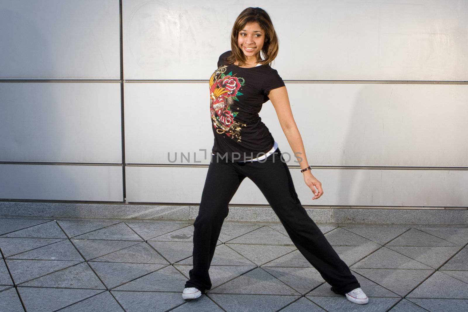 Young teenager grooving to hip hop music on the dance floor