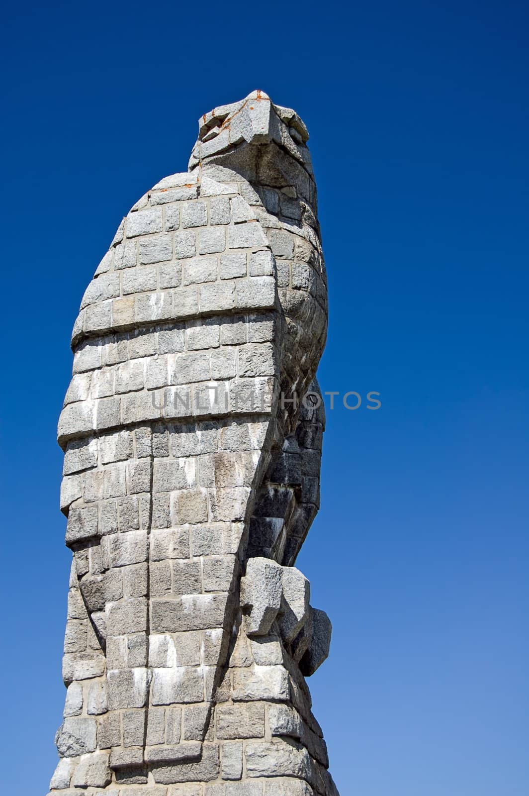 A statue of an eagle with a blue sky background