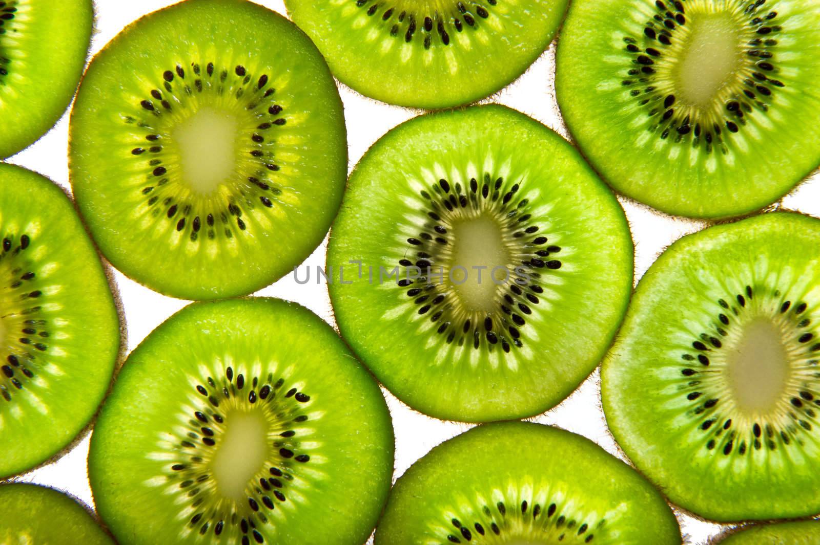 Green kiwi slices whit a white background.