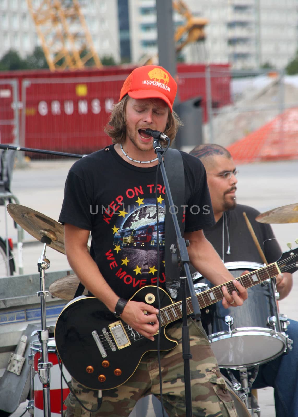 Street musician with electric guitar plays rock and roll