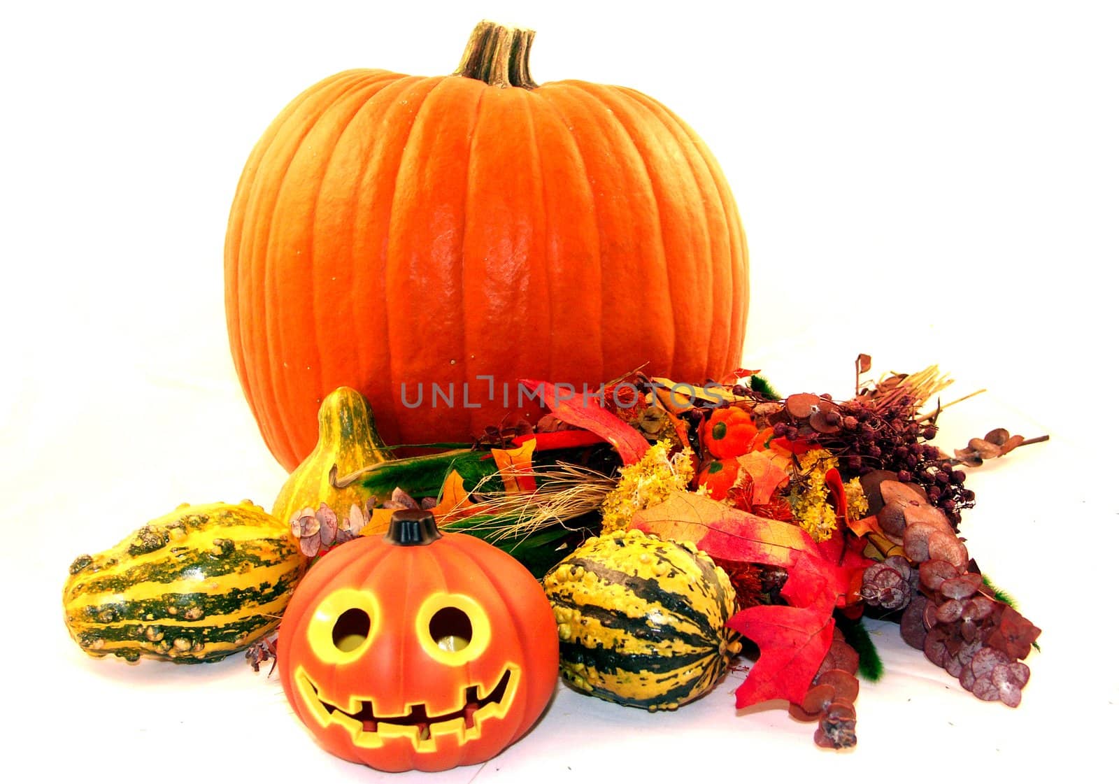 Fall holiday centerpiece with a carved and uncarved pumpkin
