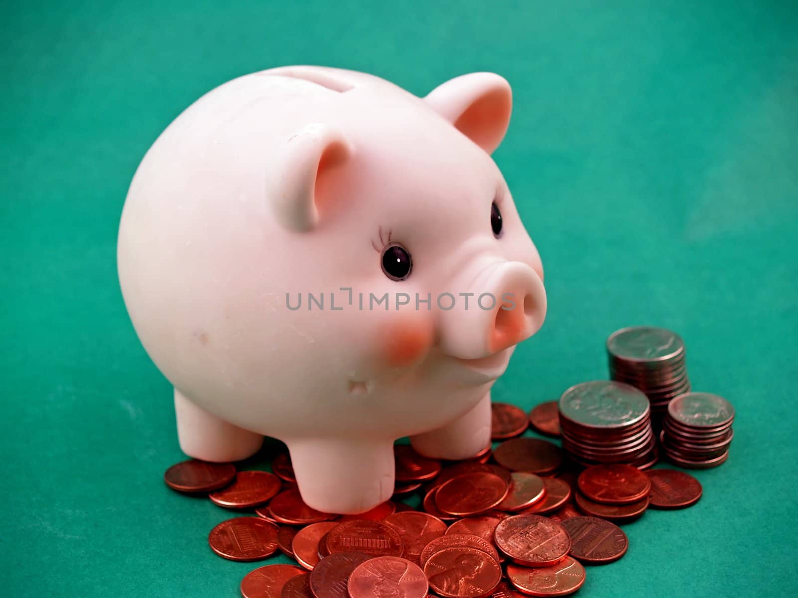 Pink piggy bank on green for easy isolatoin