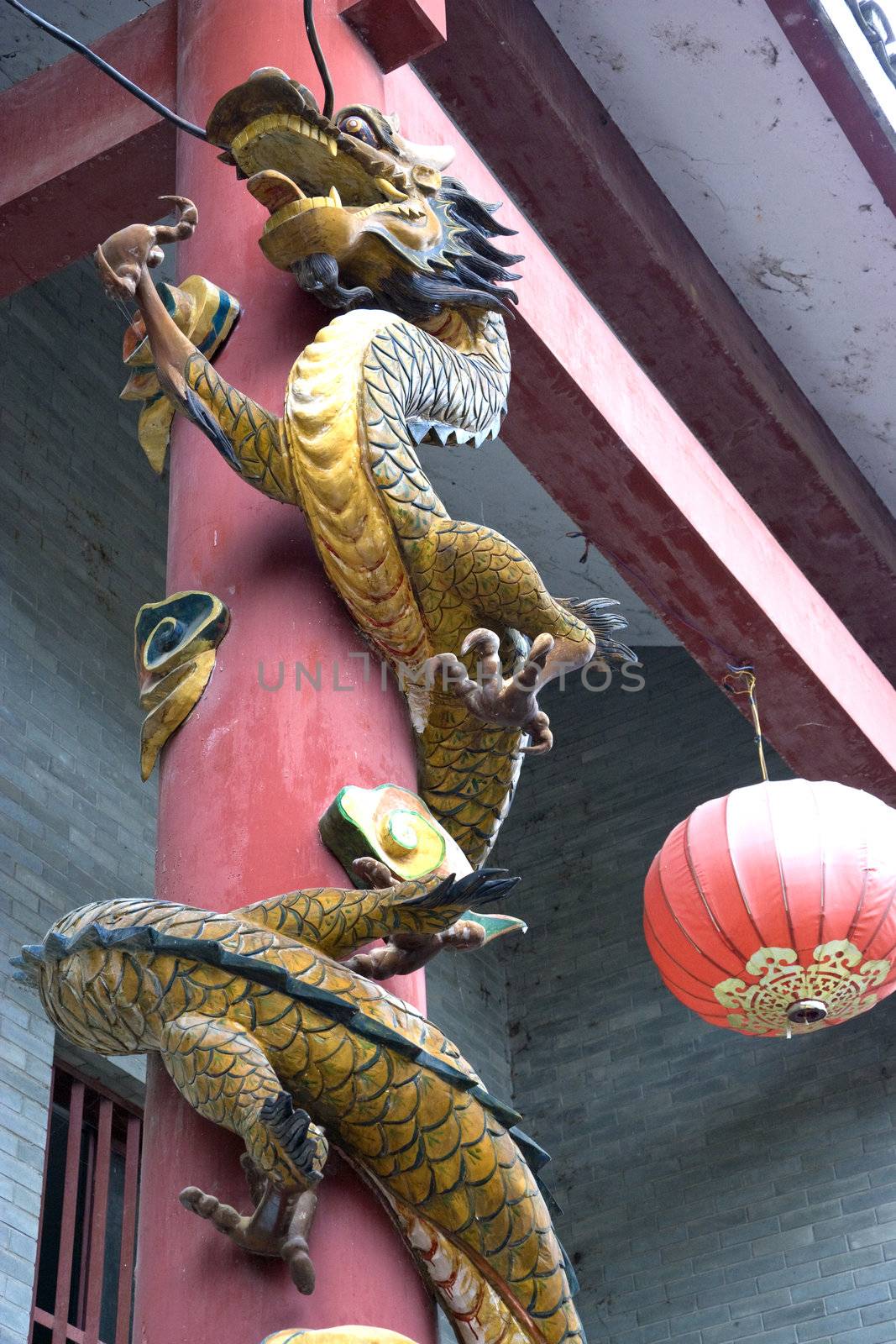 Image of a dragon carved on a pillar at the entrance of a temple that has been sealed closed apparently because it is haunted at Daxu Ancient Town, Guilin, China.