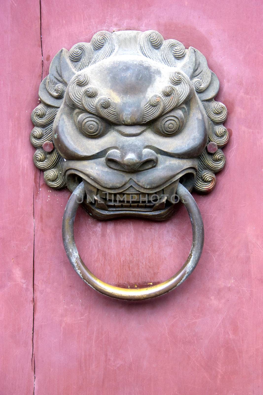 Image of an old door knob on a temple door at the ancient town of Daxu, Guilin, China.