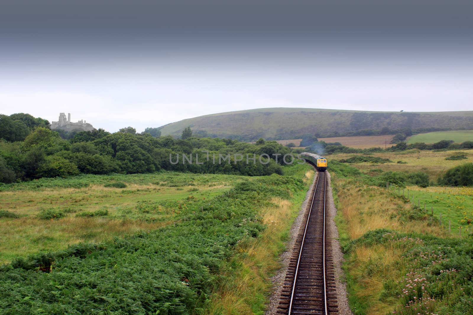 The front end of a diesel train on the Swanage railway in Dorset UK. A front on view of the train on the track shot from a small bridge between Corfe Castle and Swange.
