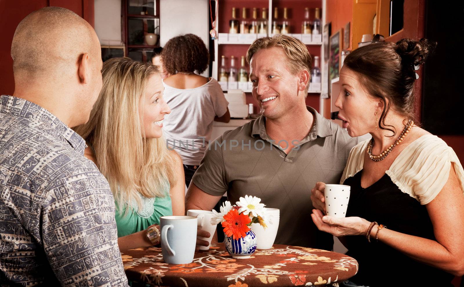 Four adult friends meeting in a coffee house