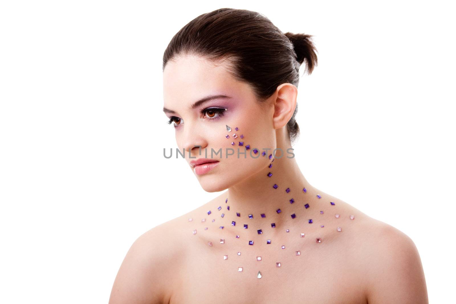 Headshot of a beautiful Caucasian woman with purple makeup and rhinestones and bare shoulders, isolated