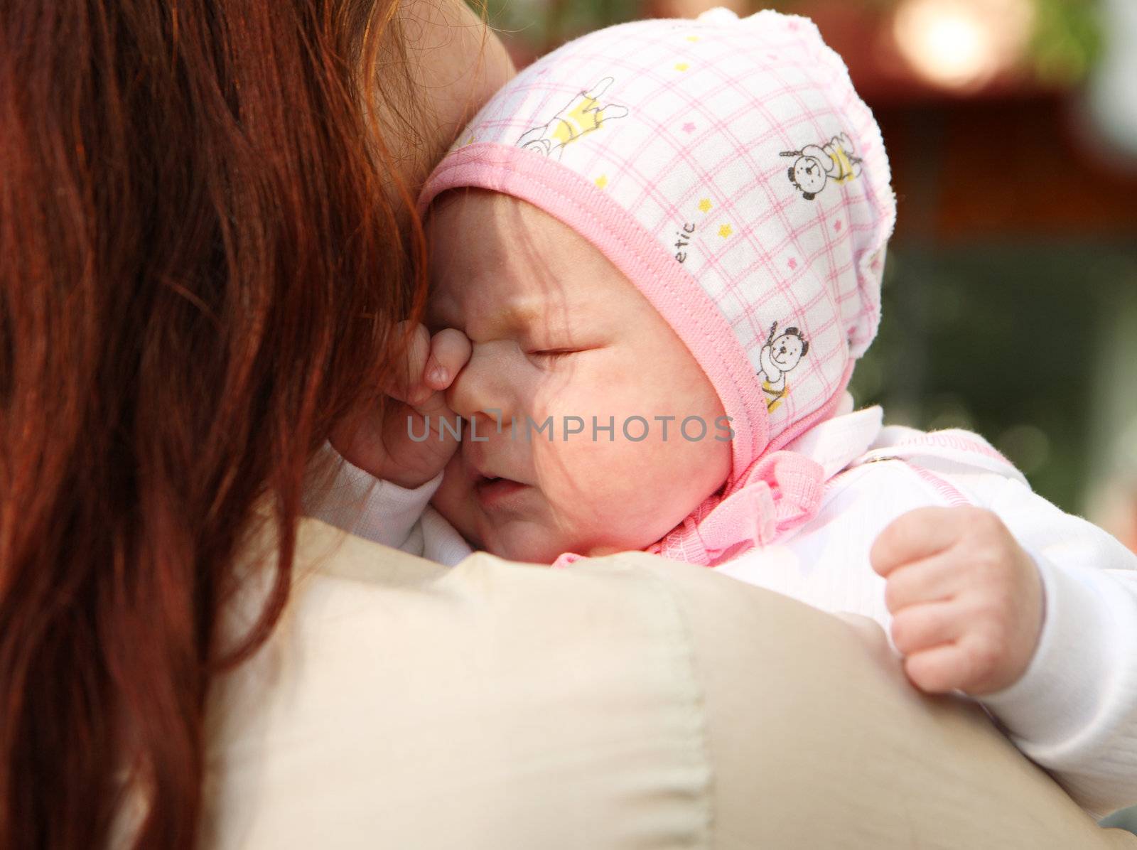 The newborn girl on mum's hands
