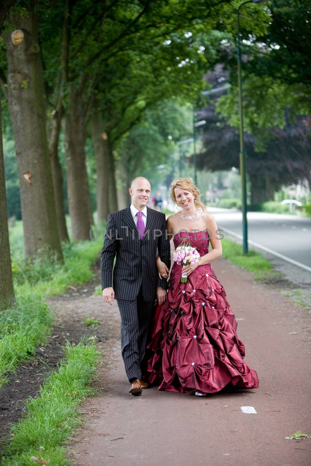 Pretty bridal couple walking together outdoors