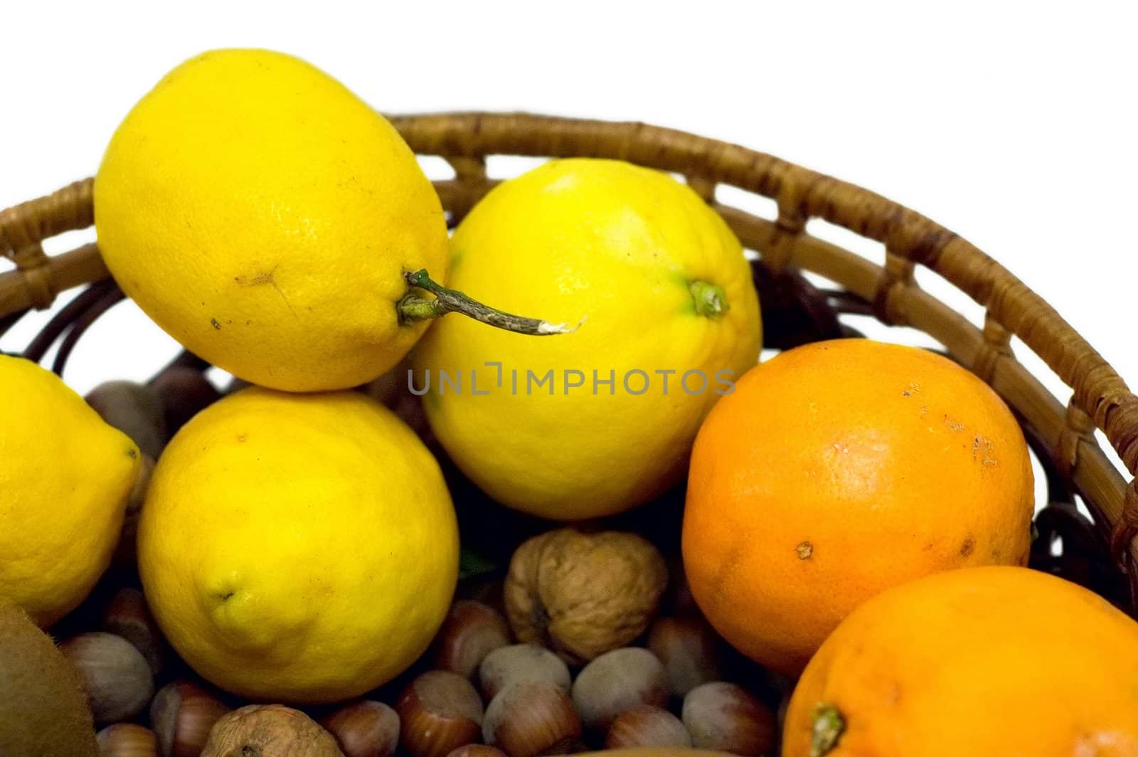 Lemon, oranges and nuts isolated on white