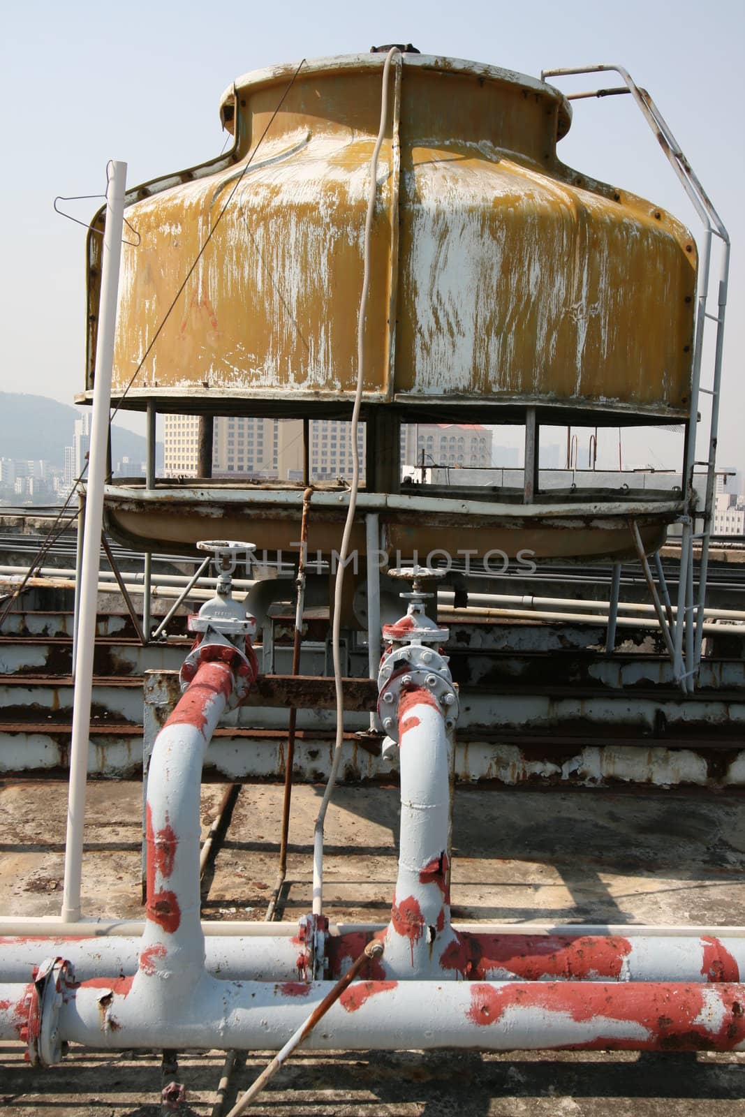 Old water tank on the roof of a Macao hotel. Still in use, despite the condition. 