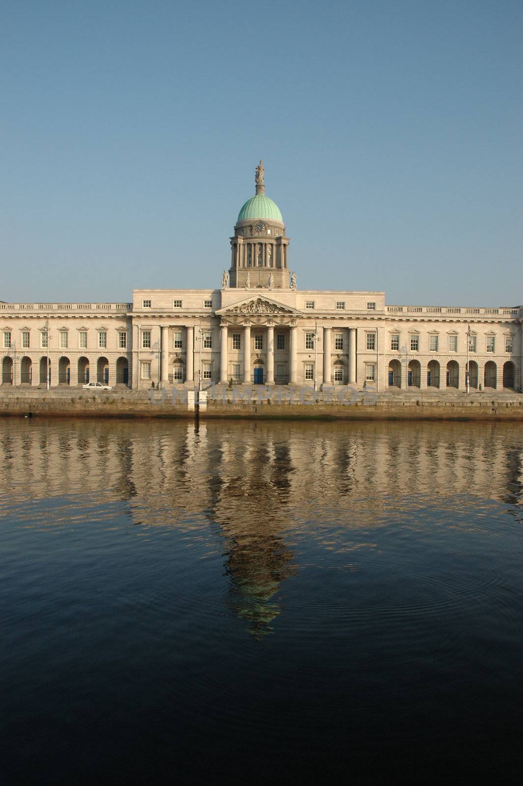 Custom House on the Quays in Dublin. A neoclassical 18th century building which now houses the Department of Environment, Heritage and Local Government. It is located on the north bank of the River Liffey, on Custom House Quay between Butt Bridge and Talbot Memorial Bridge. It was designed by James Gandon to act as the new custom house for Dublin Port. When it was completed in 1791, it cost �200,000 to build � a huge sum at the time. The four facades of the building are decorated with coats-of-arms and ornamental sculptures representing Ireland's rivers.