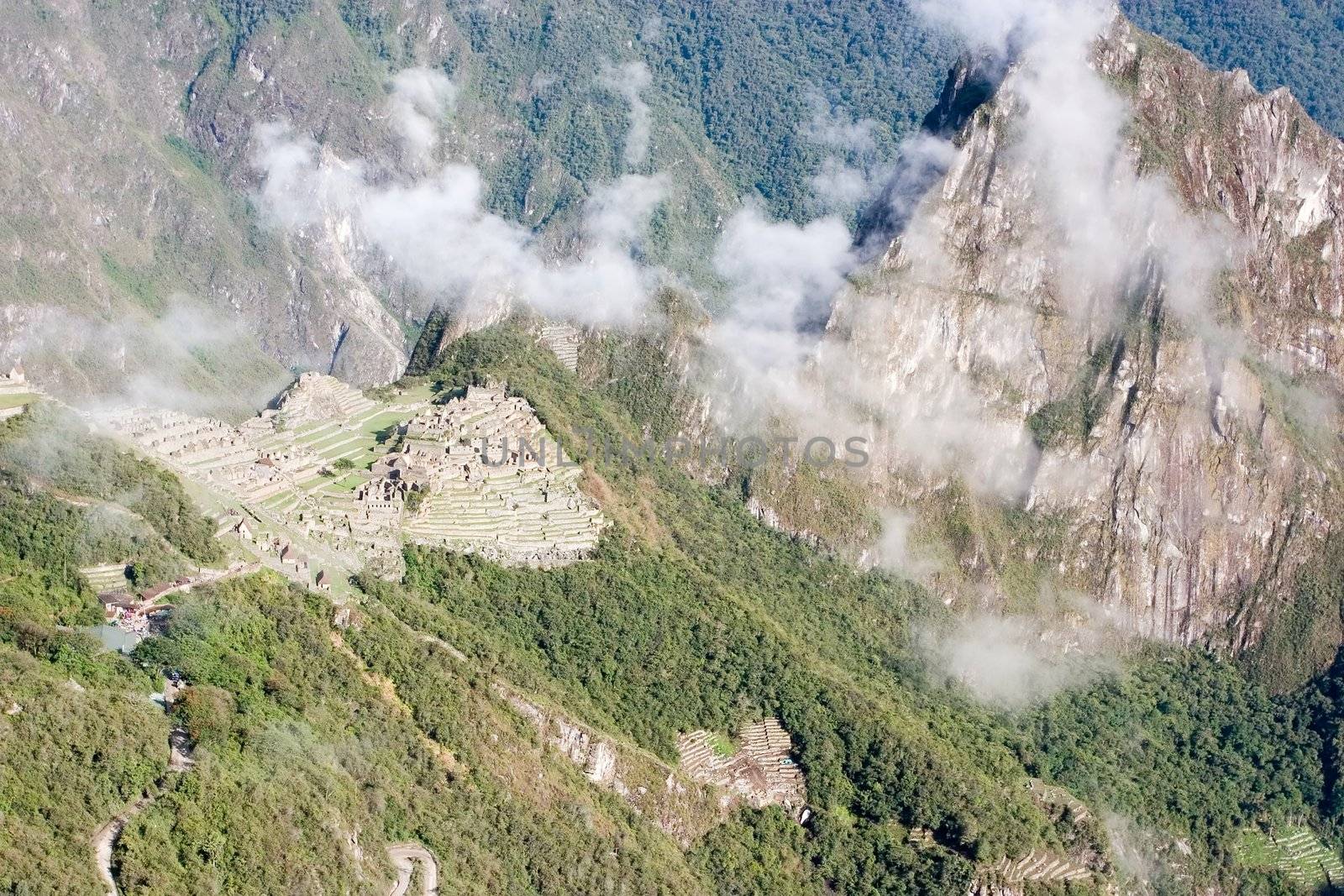 Machu Picchu (Quechua: Machu Picchu, "Old Peak") is a pre-Columbian Inca site located 2,400 meters (7,875 ft) above sea level[1]. It is situated on a mountain ridge above the Urubamba Valley in Peru, which is 80 km (50 mi) northwest of Cusco.