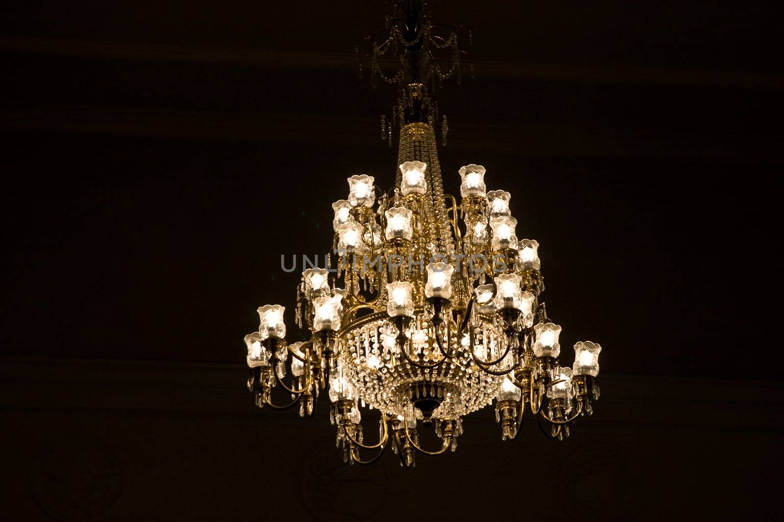 Chandelier from glass with stylish lamps over black