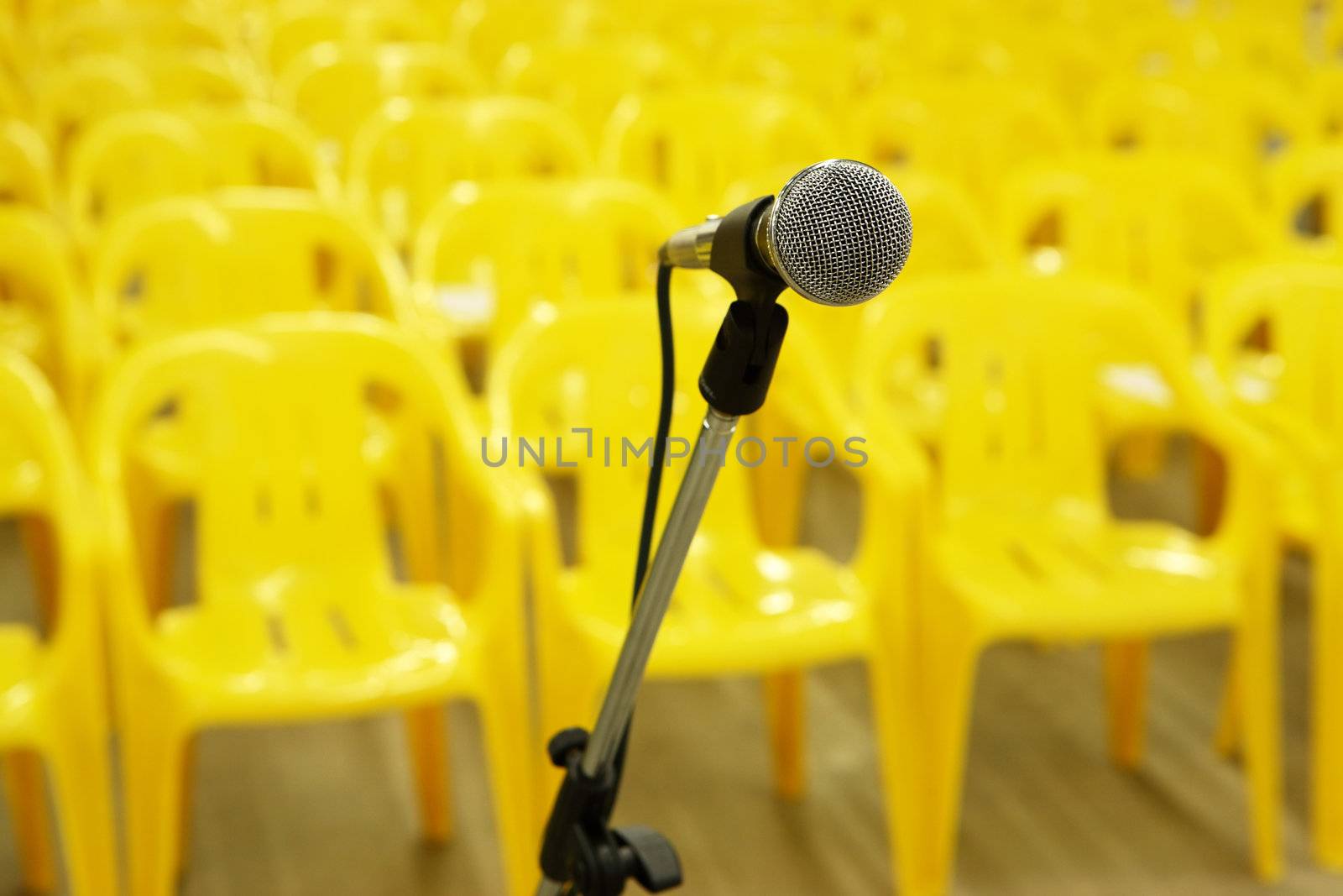 Microphone against yellow chairs
