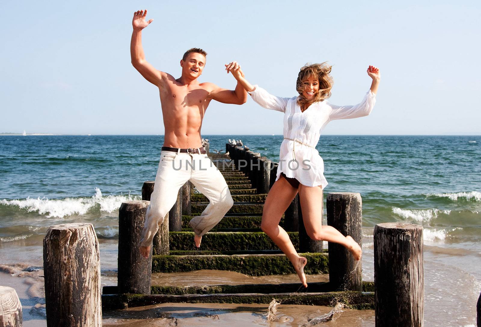 Happy couple jumping by phakimata