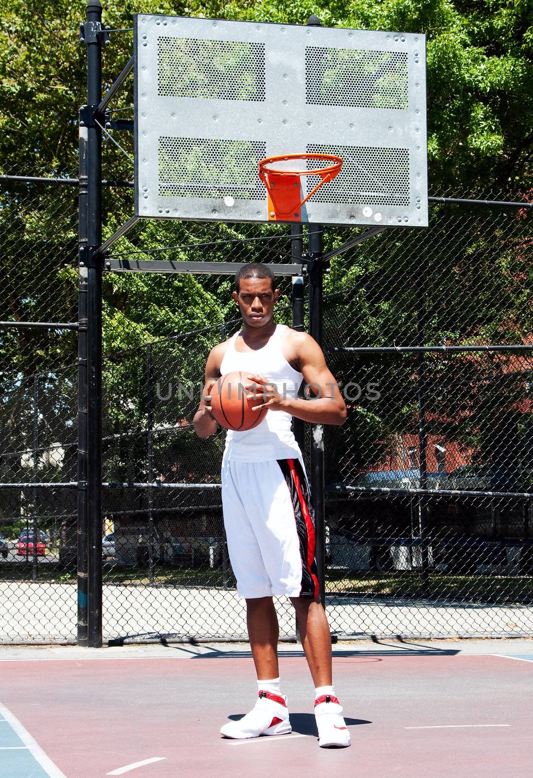 Basketball player with ball by phakimata