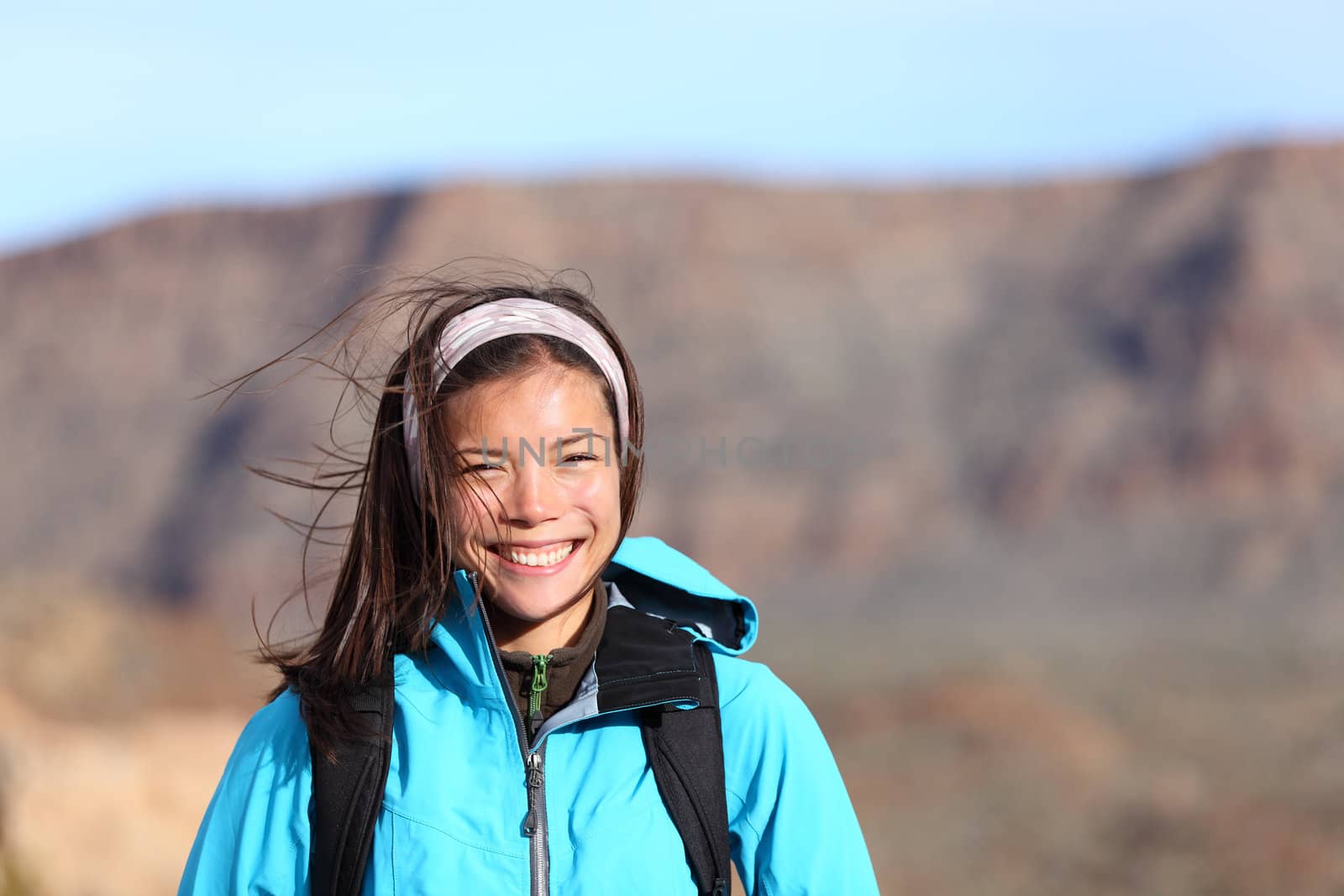 Hiker woman smiling happy during outdoors hiking. Very fresh sporty Asian Caucasian female model. Photo from Teide, Tenerife.