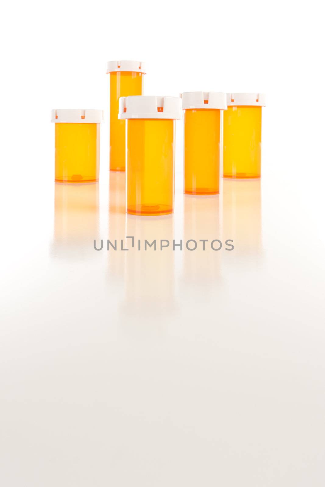 Empty Medicine Bottles on Reflective Surface by Feverpitched