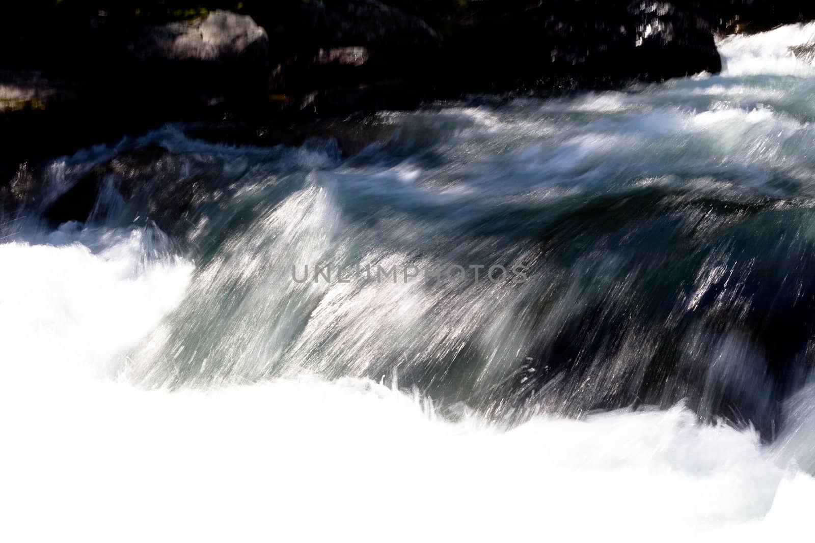 waterfall and stones in the stream 
