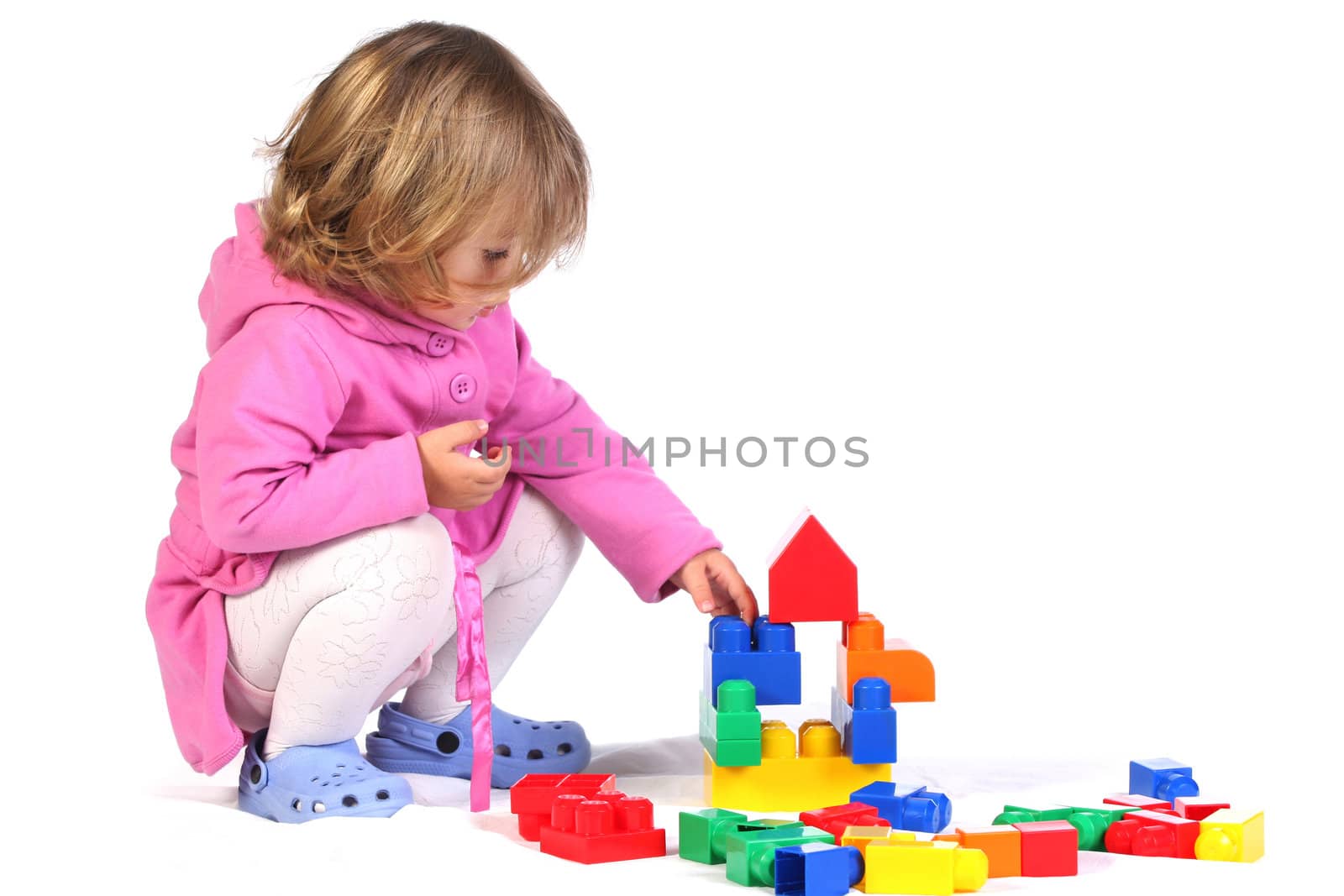 beauty a little girl with colorful blocks on white background