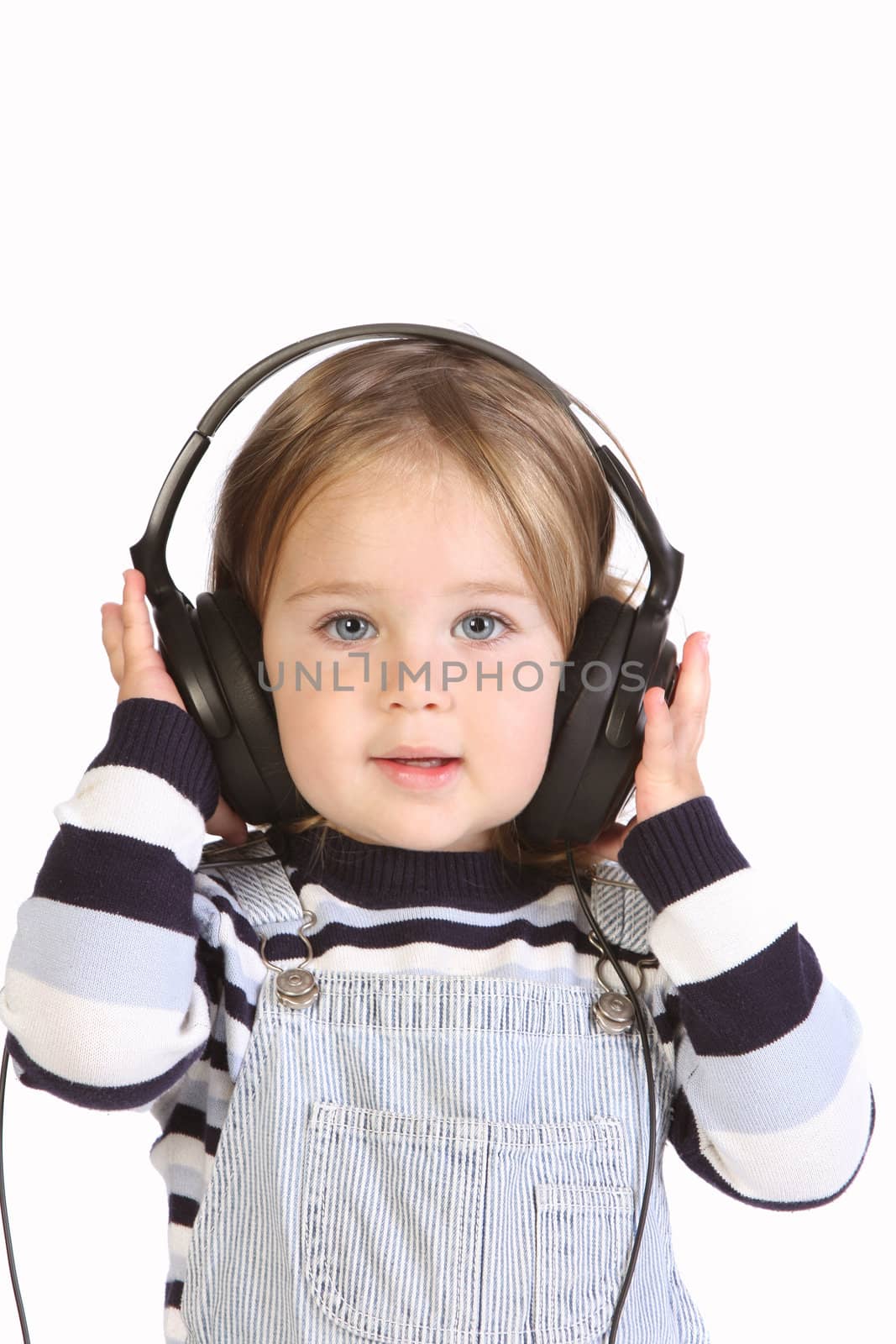 beauty a little girl listening music on white background