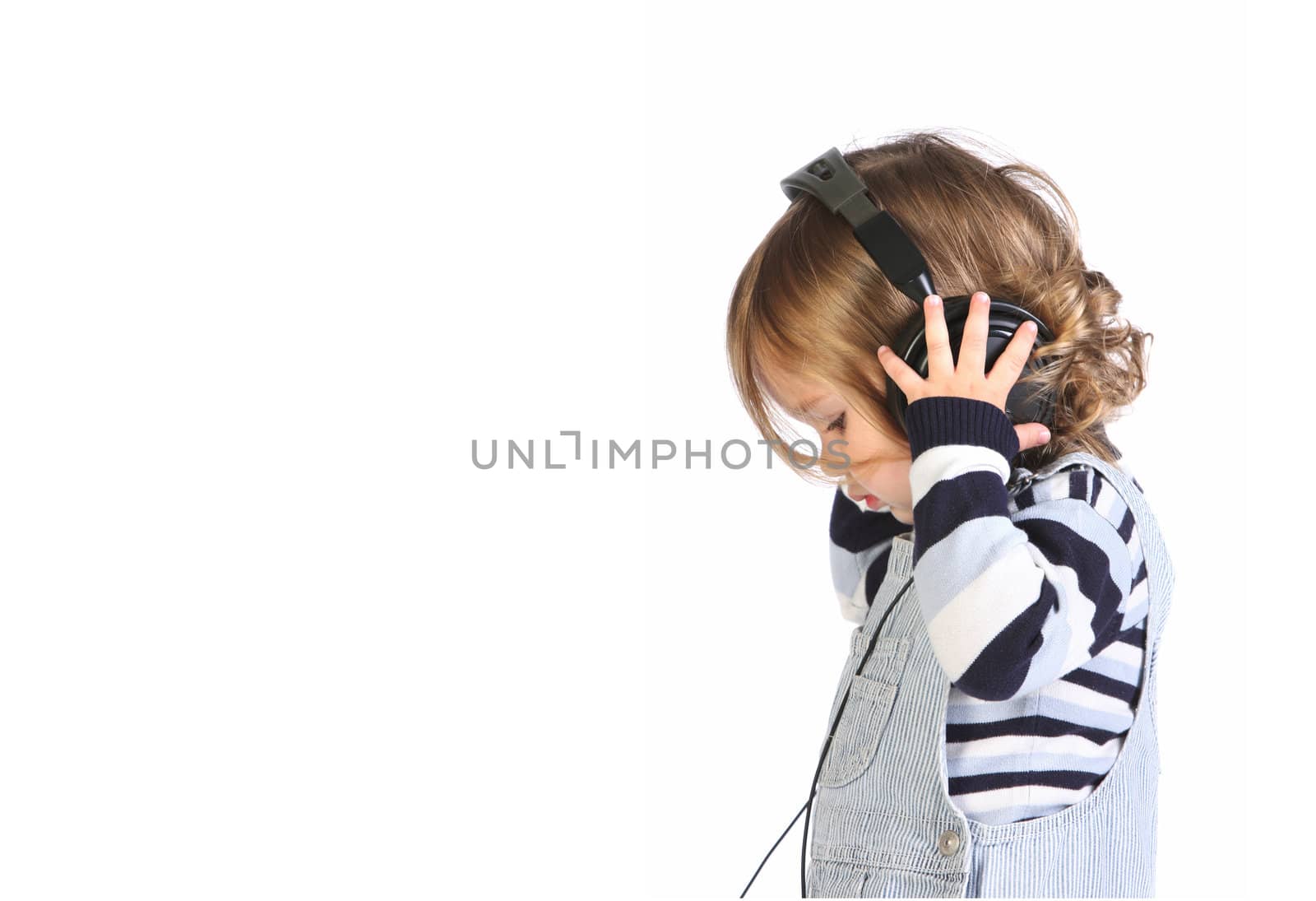 beauty a little girl listening music on white background