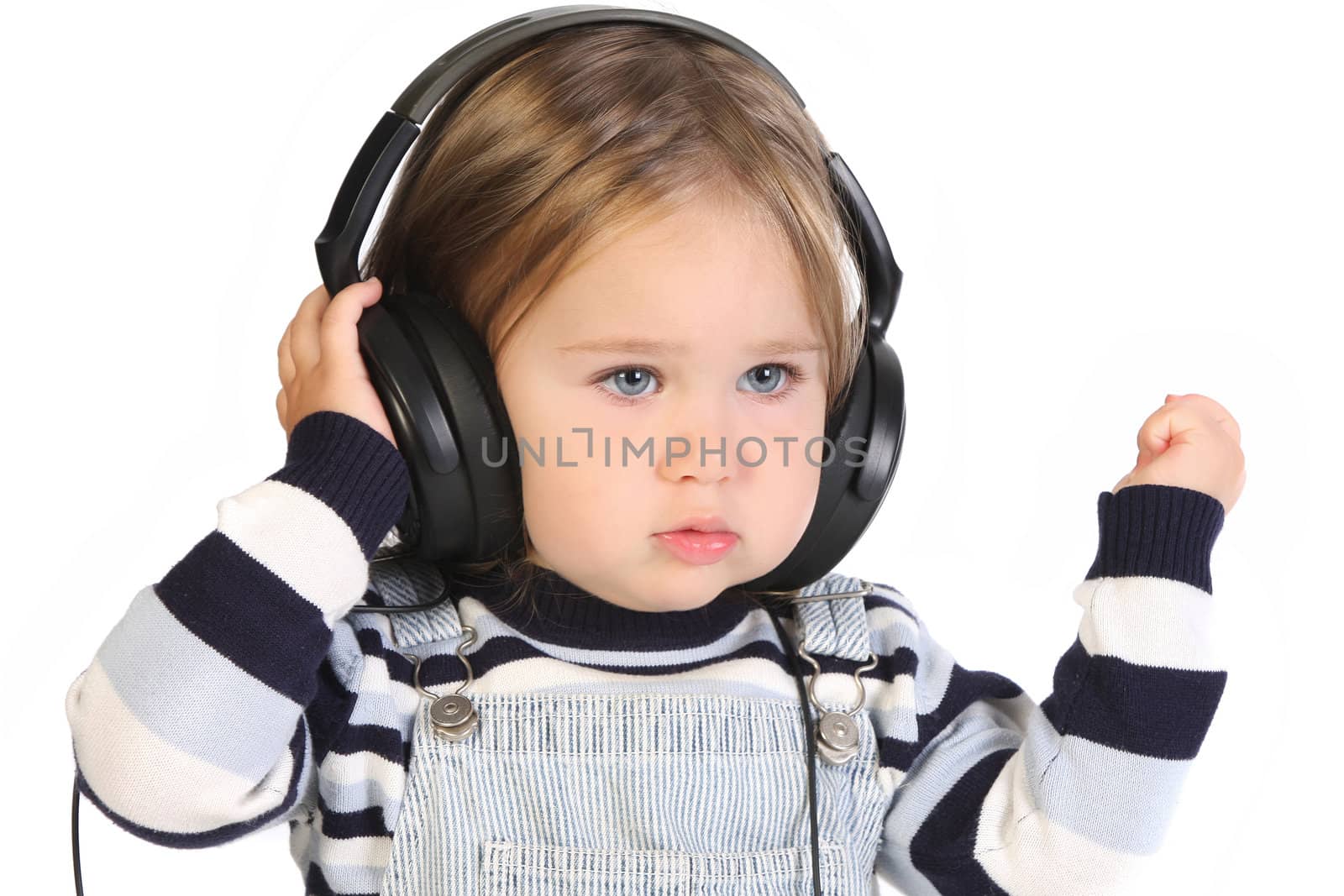 beauty a little girl listening music on white background