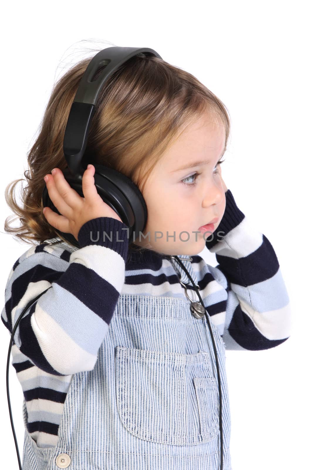 beauty a little girl listening music on white background