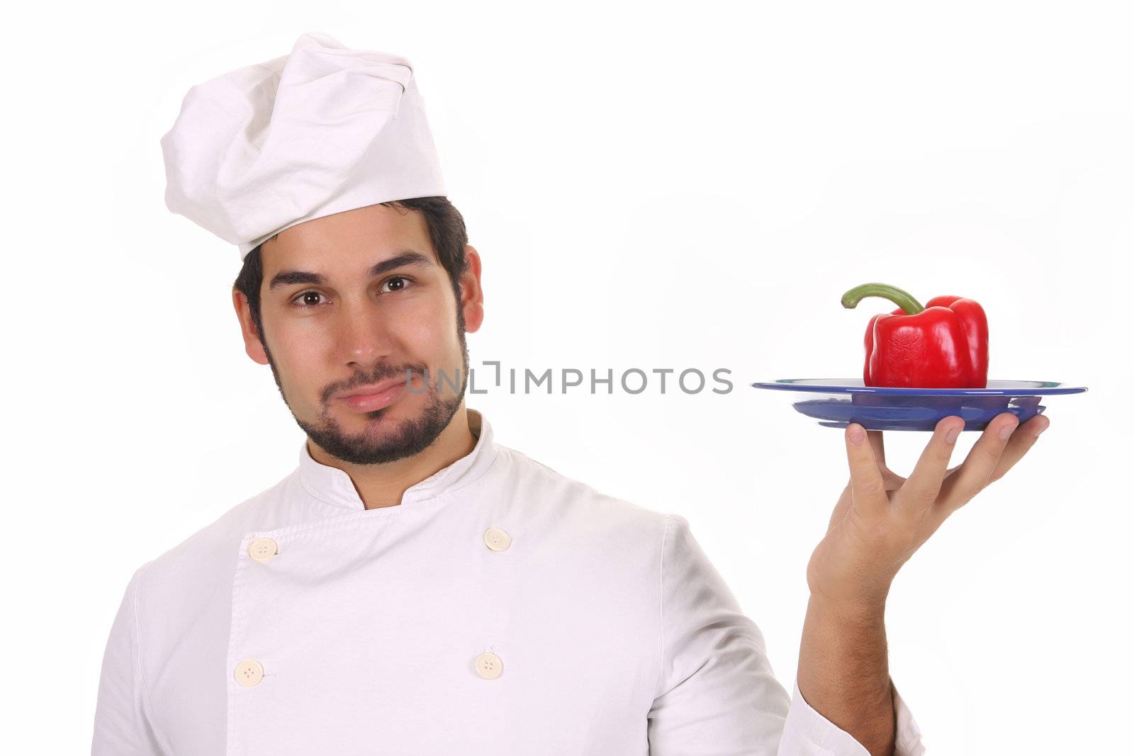 young chef holding plate with fresh pepper