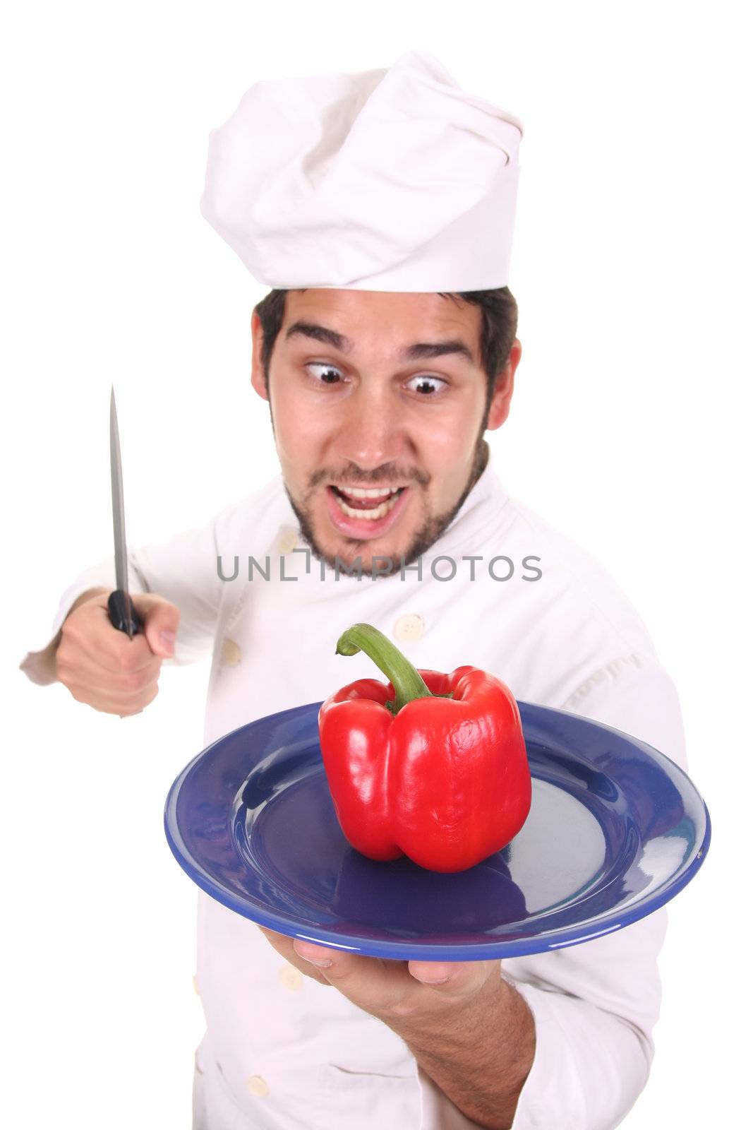 young chef holding plate with fresh pepper