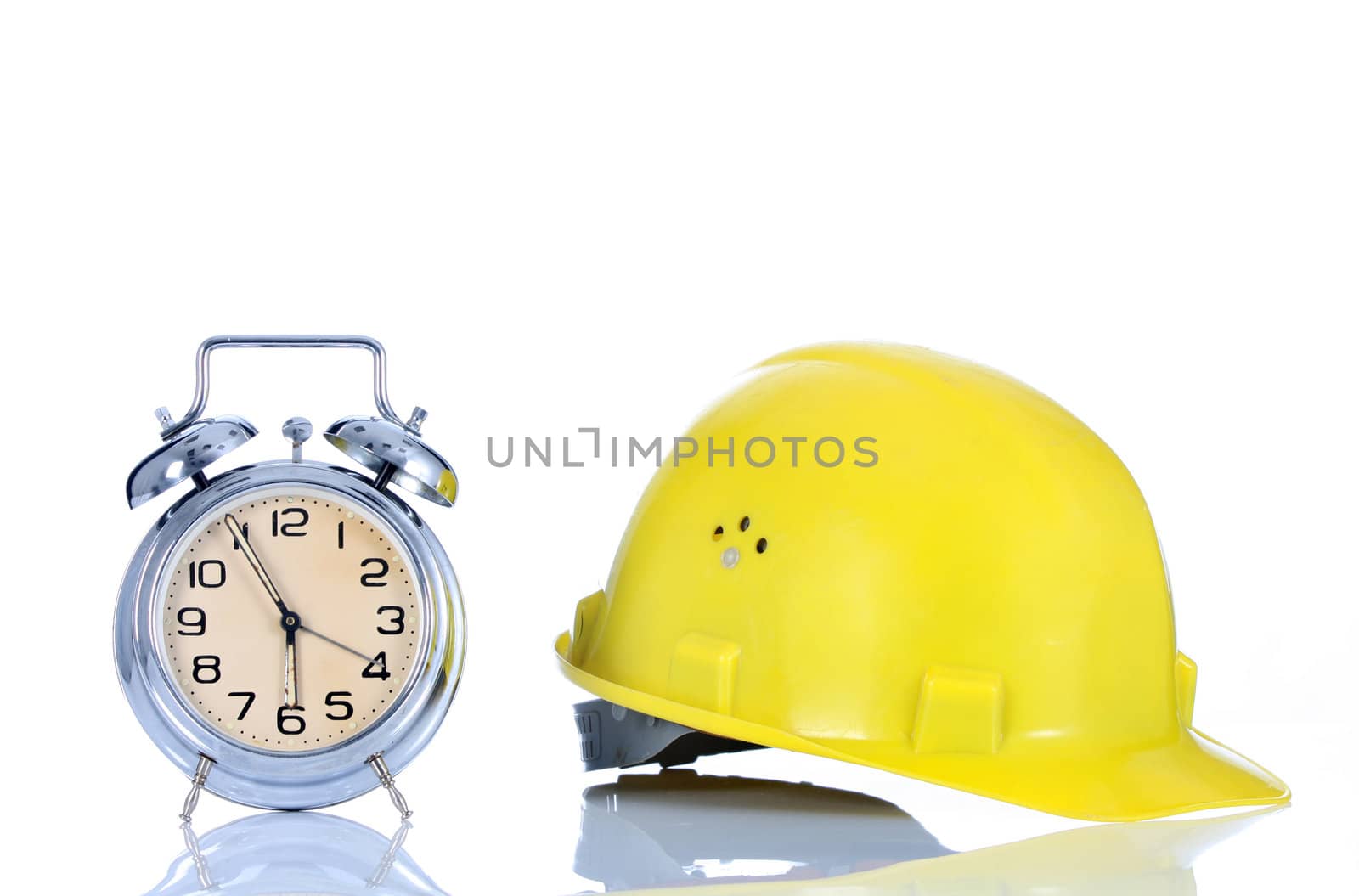 alarm clock and helmet on white background