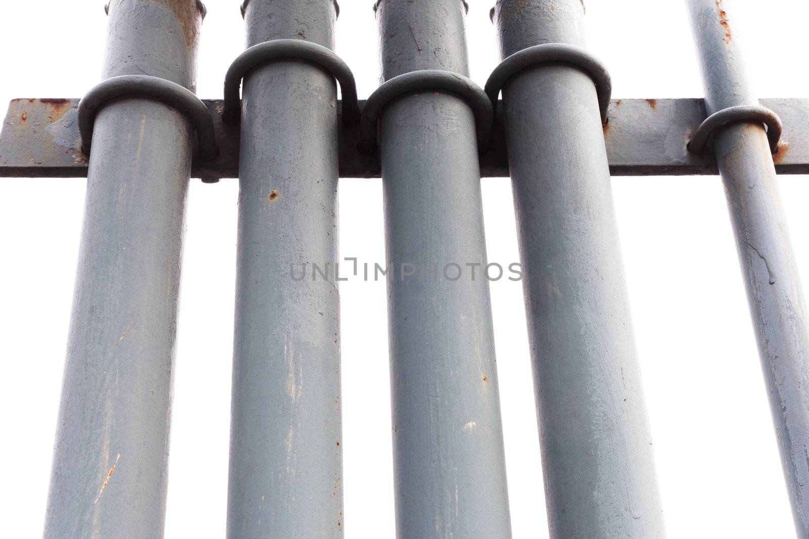 Bunch of grey painted metal pipes fastened with u-bolts isolated on white.