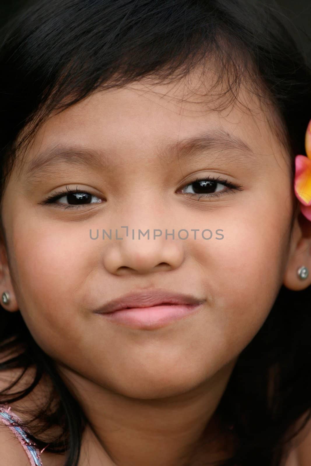 Close up face of asian little girl with a funny smile