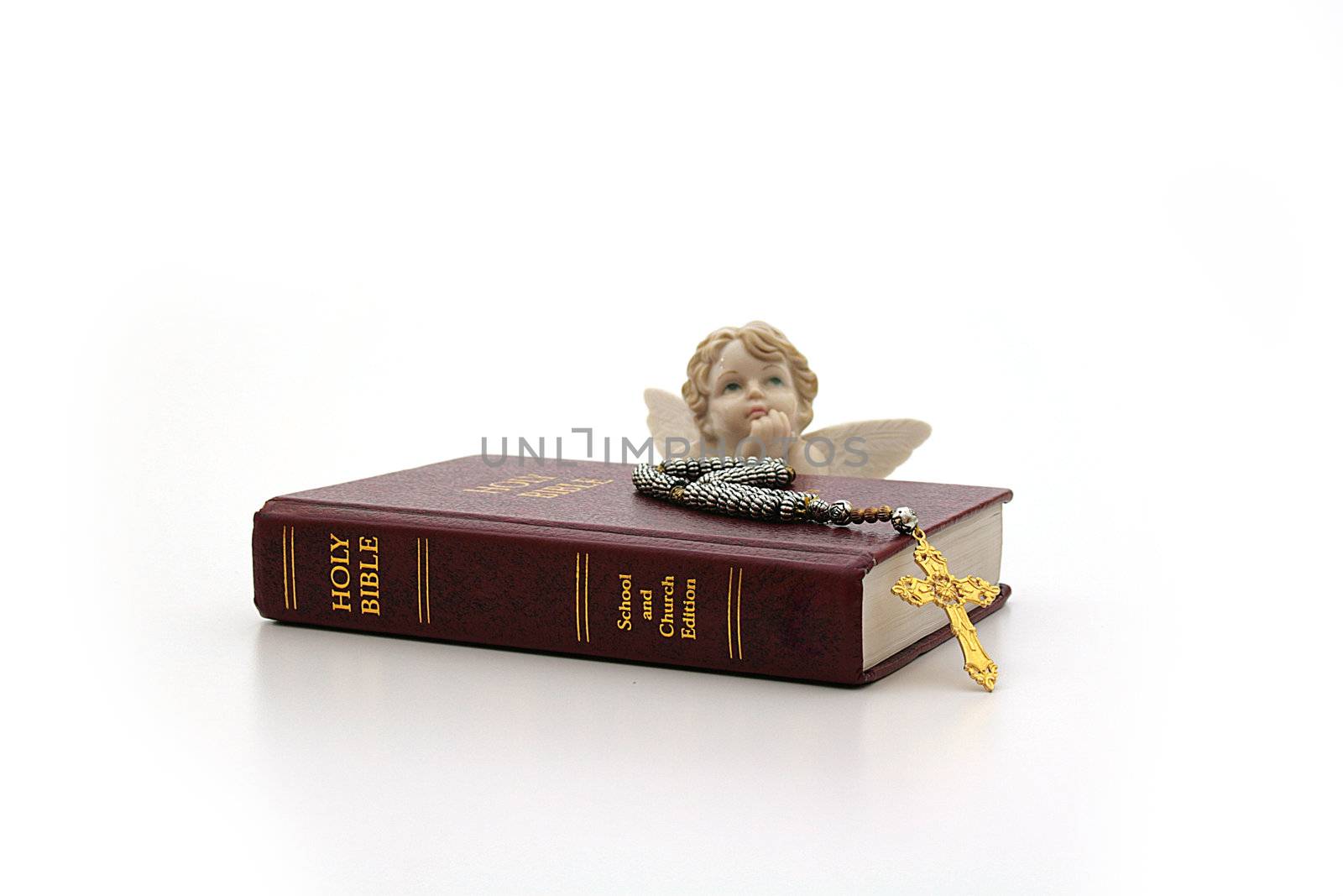 The bible and an angel on a white background.