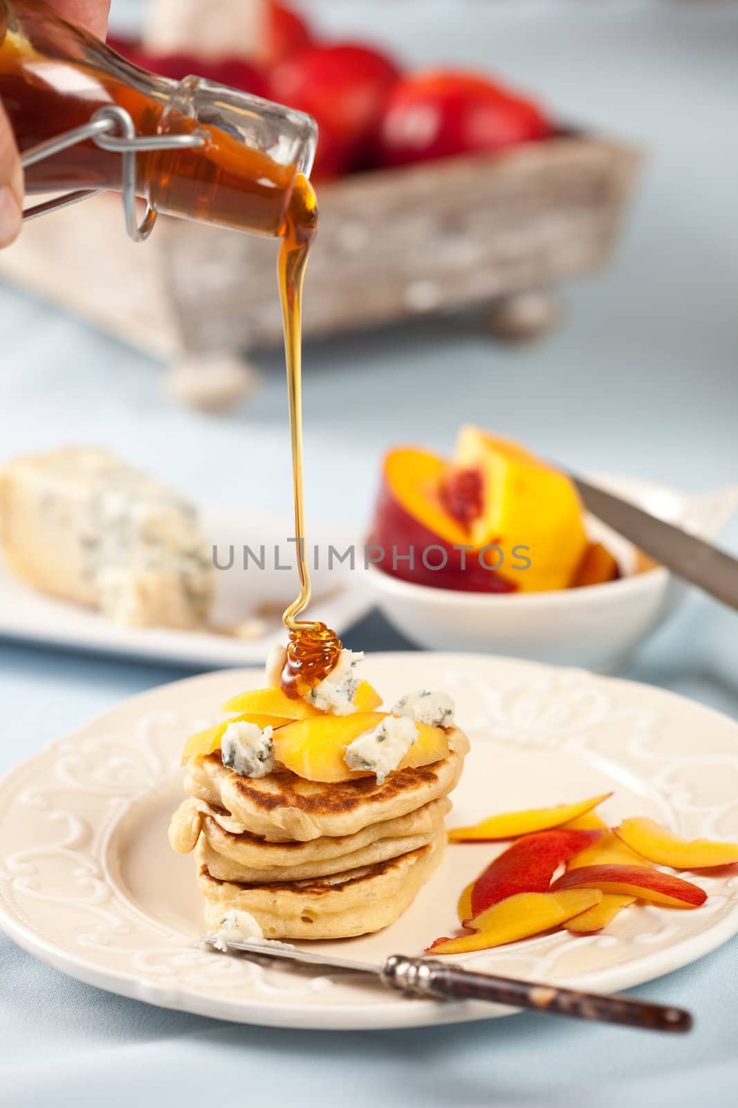 Delicious small blini's with nectarine, blue cheese and honey