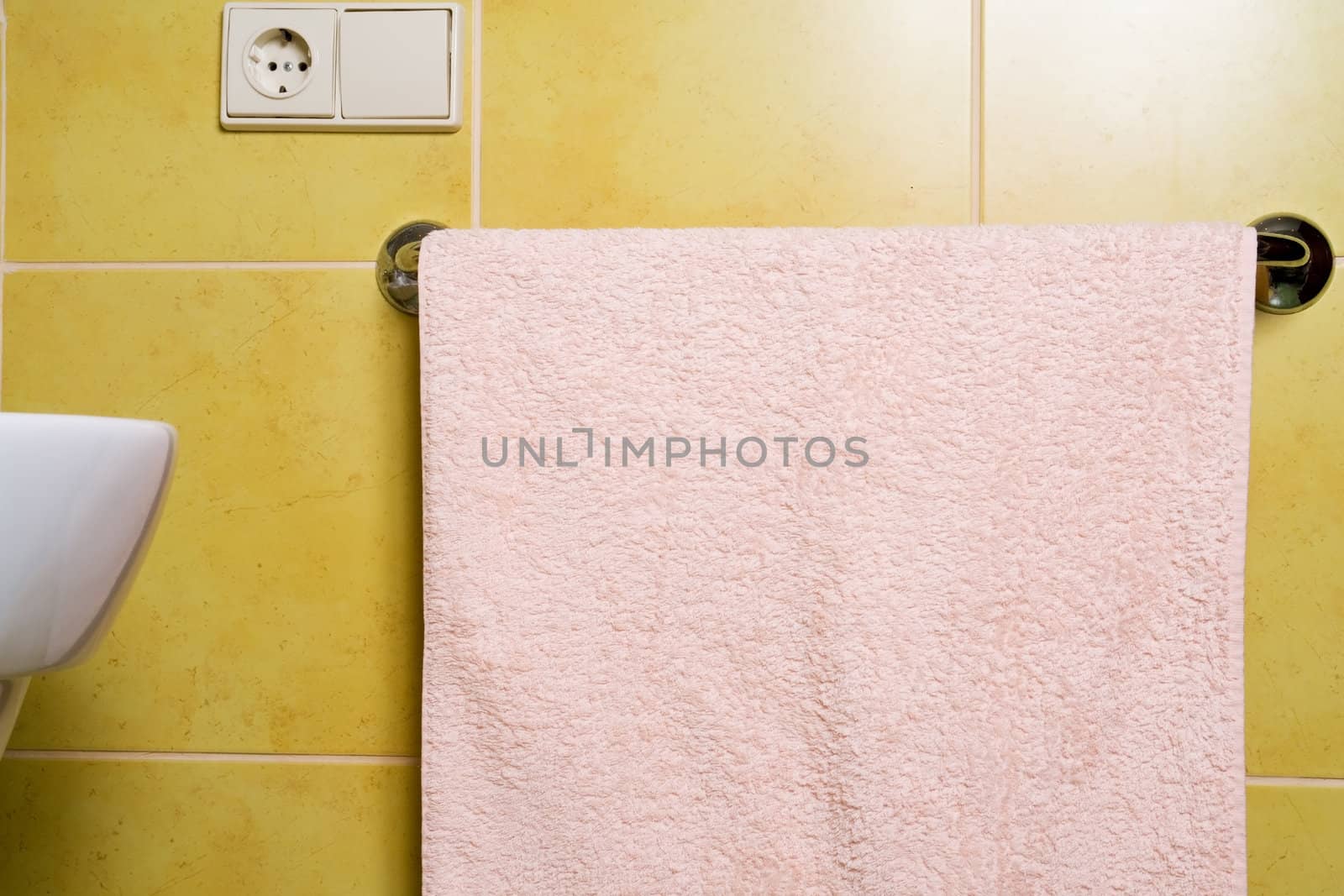  pink towel hungs in  bathroom