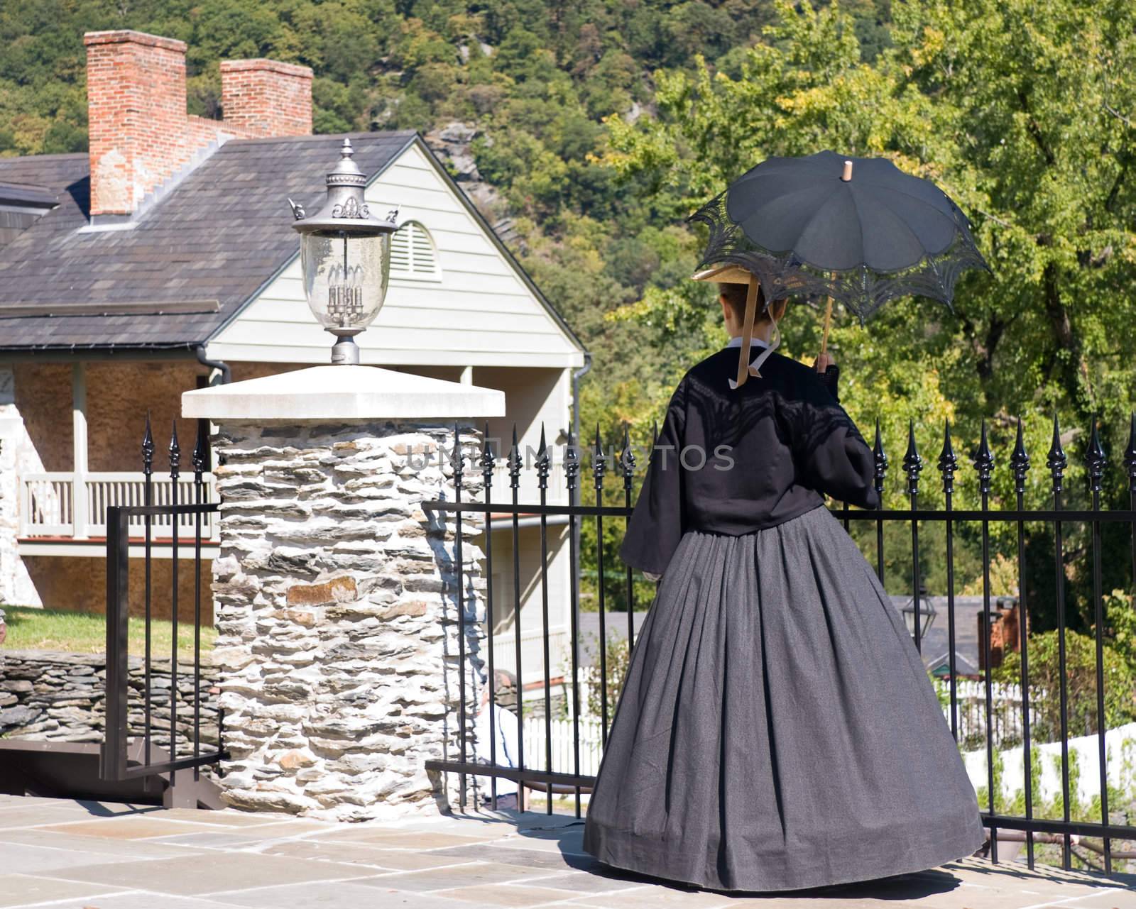 19th Century lady with parasol overlooking period houses in old town