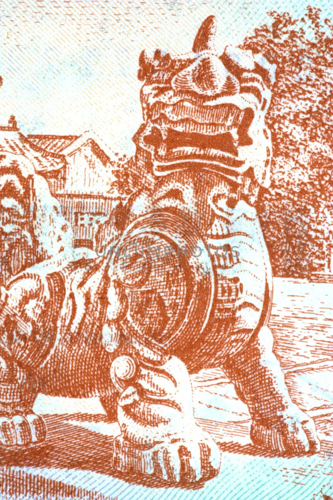Macro image of a stone guardian of a mythical animal on a currency note.