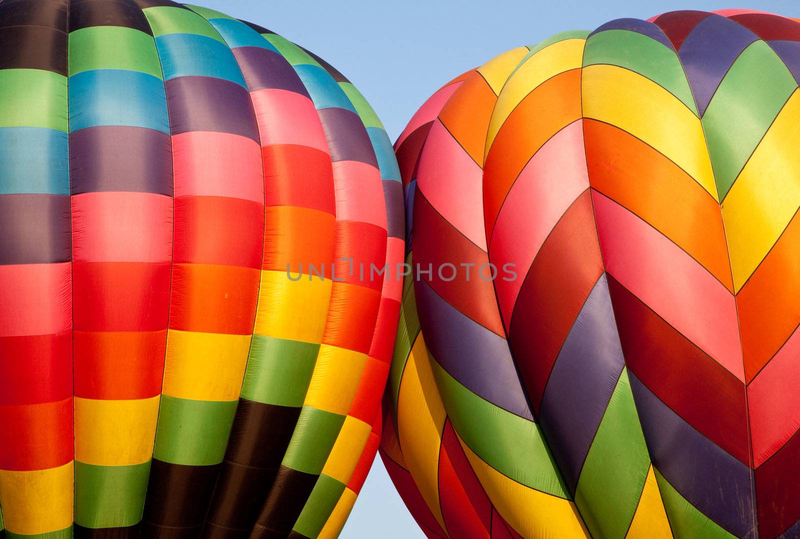 Canopies of two hot air balloons bounce against each other during inflation