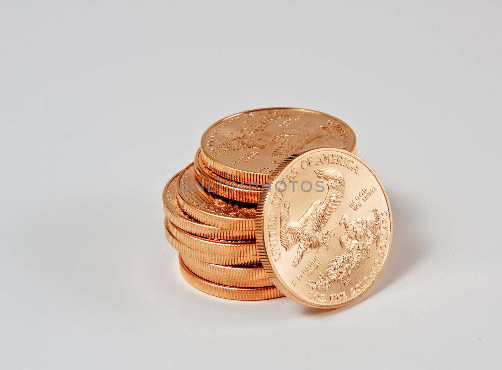 1 Ounce gold eagle coins in a stack with one coin loose