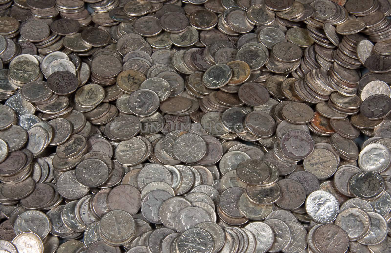 Pile of silver dime coins by steheap