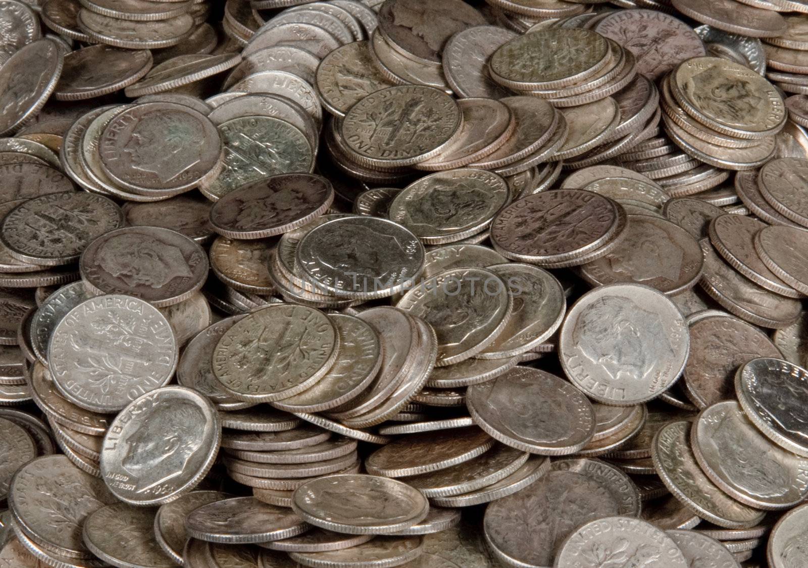 Pile of silver dime coins by steheap